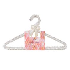 a pink and white hanger with pearls on it