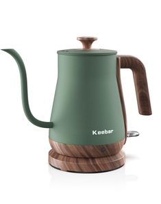 a green coffee pot with wooden handle is shown on a white surface and has the word keebar written in arabic