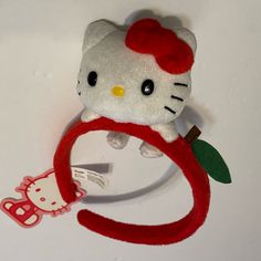 a hello kitty headband with an apple on it