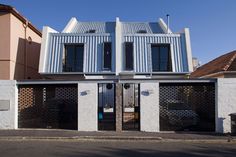 the building is made out of corrugated and has two large doors on each side of it