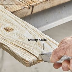 a person using a pair of scissors to cut wood planks with the words utility knife