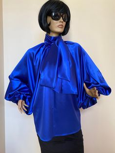 "This is a very stylish Womens Satin blouse. It is comfortable and cozy. Made for a free flowing fit. Great for all year around and for any special occasion or casual day can be dressed up or dressed down. SIZE CHART SIZE S - US 6, UK 8, EU 36 bust: bust around 34.5\"/90cm Waist: waist around 27.5\"/70cm Hips: hips around 34.5\"/90cm SIZE M - US 8, UK 10, EU 38 bust: bust around 37.5\"/95cm Waist: waist around 29.5\"/75cm Hips: hips around 37.5\"/95cm SIZE L - US 10, UK 12, EU 40 bust: bust arou Glamorous Satin Blouse For Night Out, Glamorous Satin Top For Workwear, Glamorous Long Sleeve Silk Tops, Blue Silk Blouse For Fall, Elegant Spring Tops With Satin Bow, Spring Season Glamorous Silk Blouse, Fall Party Blouse With Tie Neck, Elegant Tops With Satin Bow For Spring, Fitted Bow Blouse For Night Out