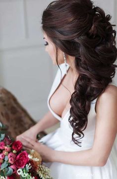 a woman with long hair holding a bouquet