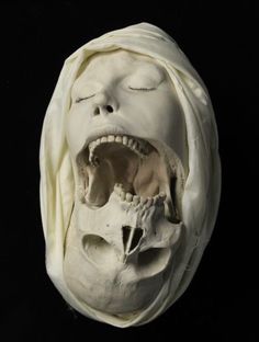 a white mask with an open mouth and teeth