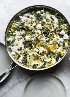 two pans filled with food sitting on top of a table