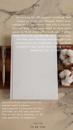 a notepad sitting on top of a wooden box next to cotton