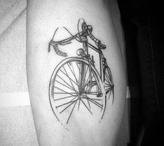 a black and white photo of a bike on someone's leg with the word love written in it