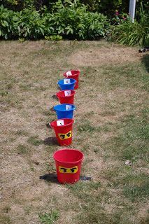 several buckets are lined up in the yard