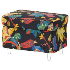 a colorful ottoman with metal legs and an upholstered floral pattern on black background