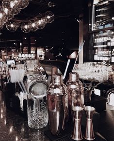 the bar has many different types of glasses and bottles on display in front of it