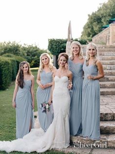 a group of women standing next to each other in front of stairs and stone steps