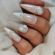 Elegant and ethereal, these wedding nails are a true work of art. Soft, pastel hues blend seamlessly with delicate floral designs, creating a dreamy and romantic look that will complement any bridal ensemble. Each nail is meticulously adorned with intricate details that exude beauty and grace, adding a touch of sophistication to the bride's overall appearance. With these stunning nails, the bride is sure to feel like a true princess on her special day. Pretty Wedding Nails Brides, Wedding Nails And Toes For Bride, 3d Wedding Nails, Nail Bride Wedding, Bridal Nails Floral, Wedding Almond Nails For Bride, Brides Nails For Wedding, Nail Designs Bride, Bridal Nails Pearl