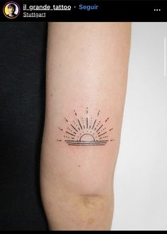 a tattoo on the arm of a woman with sun rays coming out of it's center