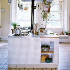 a kitchen with pots and pans hanging from the ceiling