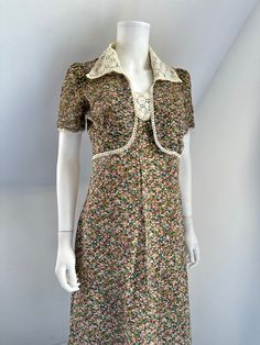 "Vintage 1970s halter neck dress with matching bolero jacket. Brown flower print on cotton mix fabric. Crochet trim, oversized collar gives 1930s vibes.  Back zipper.  Good wearable vintage condition. Some light discoloration to the collar. Chest 32\" Waist 28\" Hip 38\" Length 54\" Jacket  Chest 34\" Across back seam to seam 13\" Length 15\"" Fitted Floral Print Dress With Collar, Spring Vintage Dress With Lace Collar And Fitted Bodice, Spring Vintage Dress With Vintage Print, Fitted Retro Vintage Dress With Vintage Print, Fitted Retro Vintage Dress For Garden Party, Vintage Lace Collar Dress For Summer, Vintage Mini Dress For Garden Party, Retro Dresses With Lace Collar For Spring, Vintage Floral Print Dress For Daywear