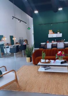 a living room filled with lots of furniture next to a green painted wall and ceiling