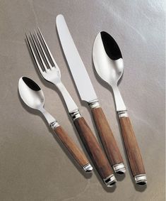 three forks, two spoons and one knife on a table