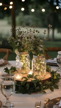 DIY wedding centerpieces with an elegant look, perfect for budget-conscious brides. Lantern Rustic Centerpieces, Homemade Wedding Table Decorations, Mason Jar Flowers Centerpiece, Tea Light Mason Jar Centerpiece, Fairy Lights On Table Wedding, Vine Centerpiece Wedding, Mason Jar Isle Decorations Wedding, Flowers In Jars Wedding