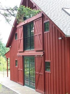 a large red barn with windows and doors