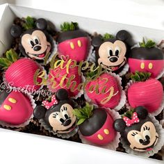 a box filled with cupcakes covered in minnie mouse decorations