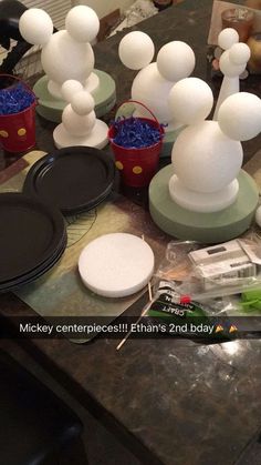 the table is covered with white plastic balls and other items that are sitting on top of it