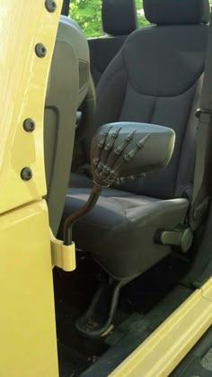 the interior of a yellow vehicle with black seats