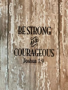 the words be strong and courageous are displayed on a wooden background with white paint stains