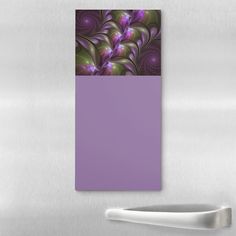 an abstract purple and green design on a refrigerator