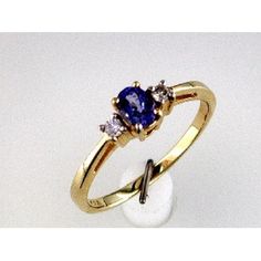 Radiant 14K Yellow Gold Tanzanite and Diamond Ring - Timeless Elegance Tanzanite And Diamond Ring, Tanzanite Diamond Ring, The Melody, Tanzanite Stone, Tanzanite Diamond, Tanzanite Ring, Baguette Cut Diamond, Royal Jewelry, Baguette Cut