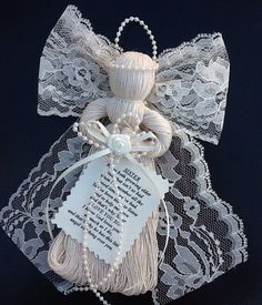 an ornament made out of lace and ribbon with a poem on the side