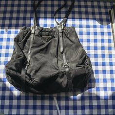 BIO90s Prada Nylon Black Handbag Stunning wee bag the perfect shape size devine thick nylon, yummy silver hardware and leather details and cute little bow at the front   Comes with authentication cards :) In very good condition for age interior and exterior are good, has always been kept in dust bag when not in use. Minor signs of use to be expected of second hand item only flaw is small repair to the leather strap that isnt noticeable a unless looking really closely see last pic ICONIC FOR EVER Elegant Nylon Bag For On-the-go, 90s Prada, Prada Nylon Re Edition, Prada Nylon Handbags, 90s Bag, Prada Nylon Tote, Prada Nylon Bag, Prada Nylon, Black Handbag