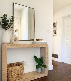 a wooden shelf sitting on top of a hard wood floor next to a white wall