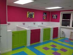 a brightly colored bathroom with pink, green and purple stalls on the wall next to each other