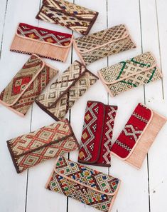 several pieces of cloth laid out on a white wooden floor with different colors and patterns