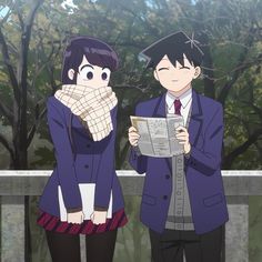 two people standing next to each other in front of trees and one person holding a newspaper