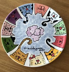 a colorful plate with cats painted on it