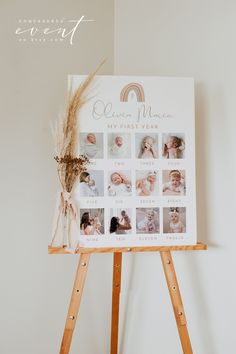 a baby's first year calendar is displayed on a easel with dried flowers