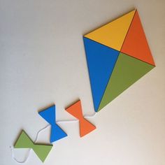 two colorful kites are hanging on the wall