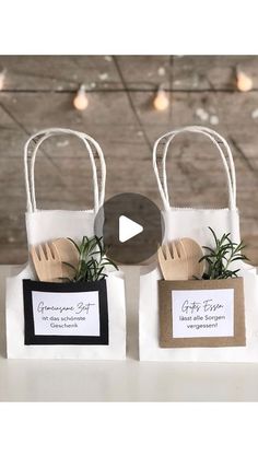 two small bags with forks and plants in them