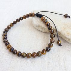 This Wrist Tasbih bracelet is made with 6mm Tigers eye beads. 33 beads used for dhikr and remembrance of Allah. Ideal gift for men or women. This bracelet is adjustable for wrist sizes between 7.5-9 inches. This tasbih has 8 inche inside diameter. Tiger's Eye is known as a protective stone traditionally carried as a talisman against ill wishing and curses it shows to how to correctly use the power given to you. Tiger Eye assists in accomplishing goals, recognizing inner resources and urging clarity of intention. It is an excellent stone to take with you for exams and important meetings. Tiger Eye will increase feelings of self-worth, overcome the habit of self-criticism and clear blocked creativity. Tiger balances the lower chakras, balances Yin and Yang and energizes the emotions. It ease Brown Braided Bracelets With 8mm Beads, Adjustable Evil Eye Bracelet With Gemstone Beads, Casual Adjustable Evil Eye Bracelet With Round Beads, Adjustable Evil Eye Bracelet With 8mm Beads, Adjustable Spiritual Evil Eye Bracelet With Round Beads, Adjustable Brown Beaded Bracelets For Meditation, Casual Adjustable Rosary Bracelet With 8mm Beads, Adjustable Brown Rosary Bracelet For Meditation, Tasbih Bracelet