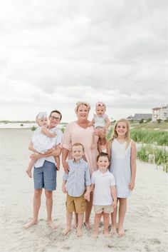 a family poses for a photo on the beach