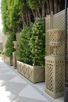 a row of planters sitting next to each other on a sidewalk