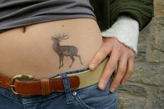 a person with a deer tattoo on their stomach