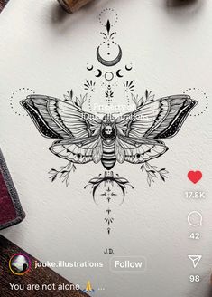 a drawing of a moth on top of a piece of paper