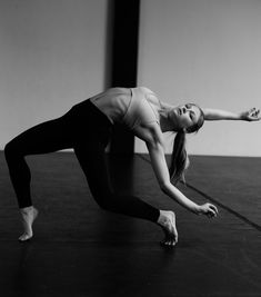 a woman is doing yoga on the floor