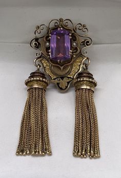 Antique Victorian Art Nouveau Piece. 14k Gold Mourning Black Enamel Jewelry, Large Amethyst and Seed Pearl with Tassel Gold in each side Very Unique Jewelry Pendant Brooch total weight 29.4 grams item not stamped but acid test past for 14k and the amethyst stone is DIA test past natural stone 16x10mm emerald cut and about 10 carat perfect to add in your collection. Purple Brooch Jewelry For Evening, Amethyst Brooch For Anniversary, Amethyst Brooch Jewelry For Anniversary, Elegant Gold Amethyst Brooches, Purple Amethyst Brooch, Blue Christmas Tree, Pendant Brooch, Gorgeous Christmas, Victorian Art