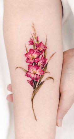 a woman's arm with pink flowers on it