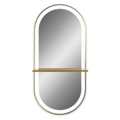 an oval shaped mirror with gold trimmings and a shelf on the side, against a white background