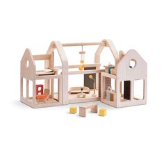 a wooden dollhouse with furniture and accessories for the house, side by side on a white background