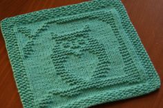 a green crocheted square on top of a wooden table